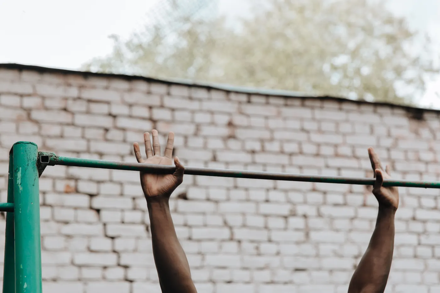 Close view of hands gripping a pull-up bar