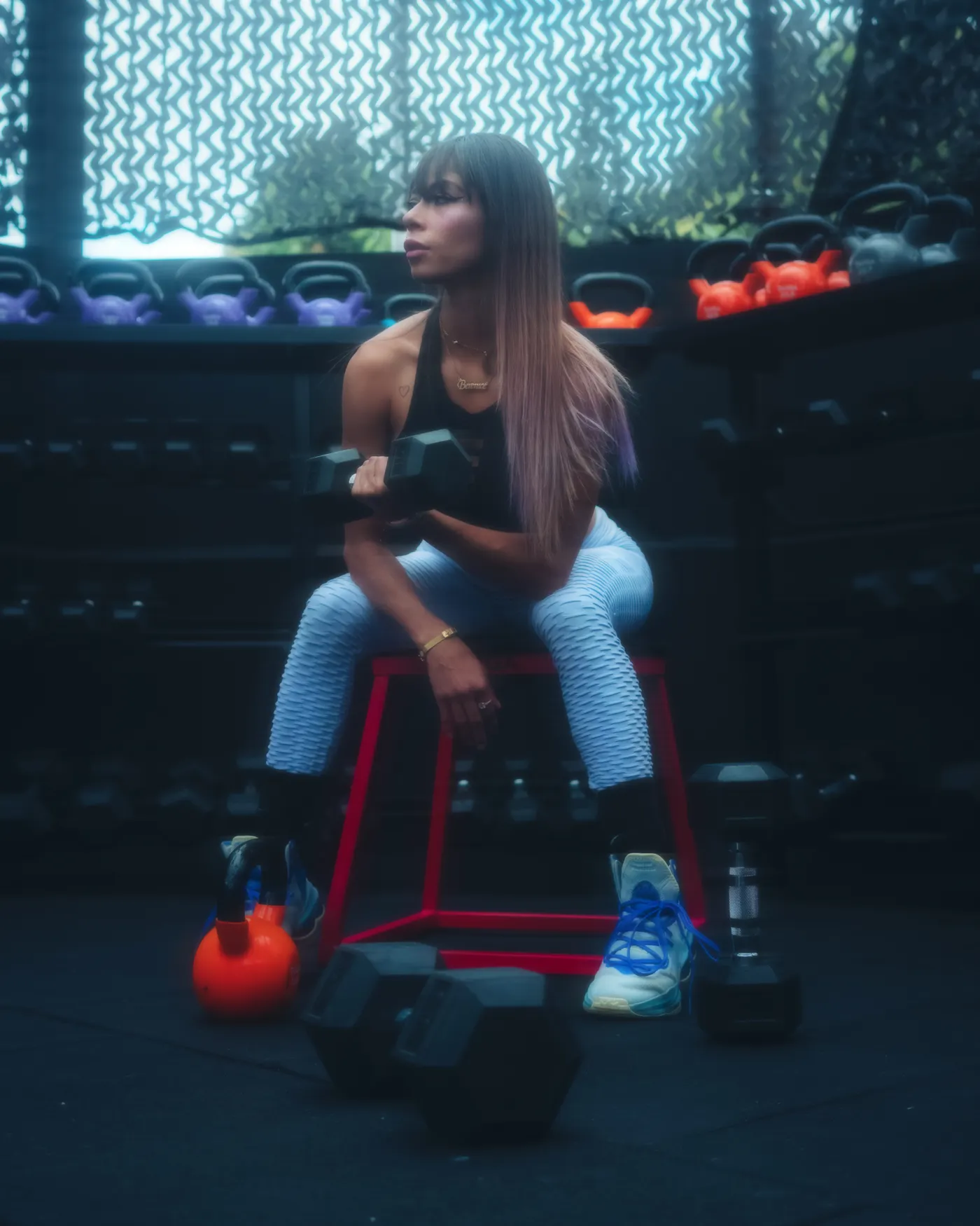 Woman lifting dumbbells, illustrating muscle-preserving strength training