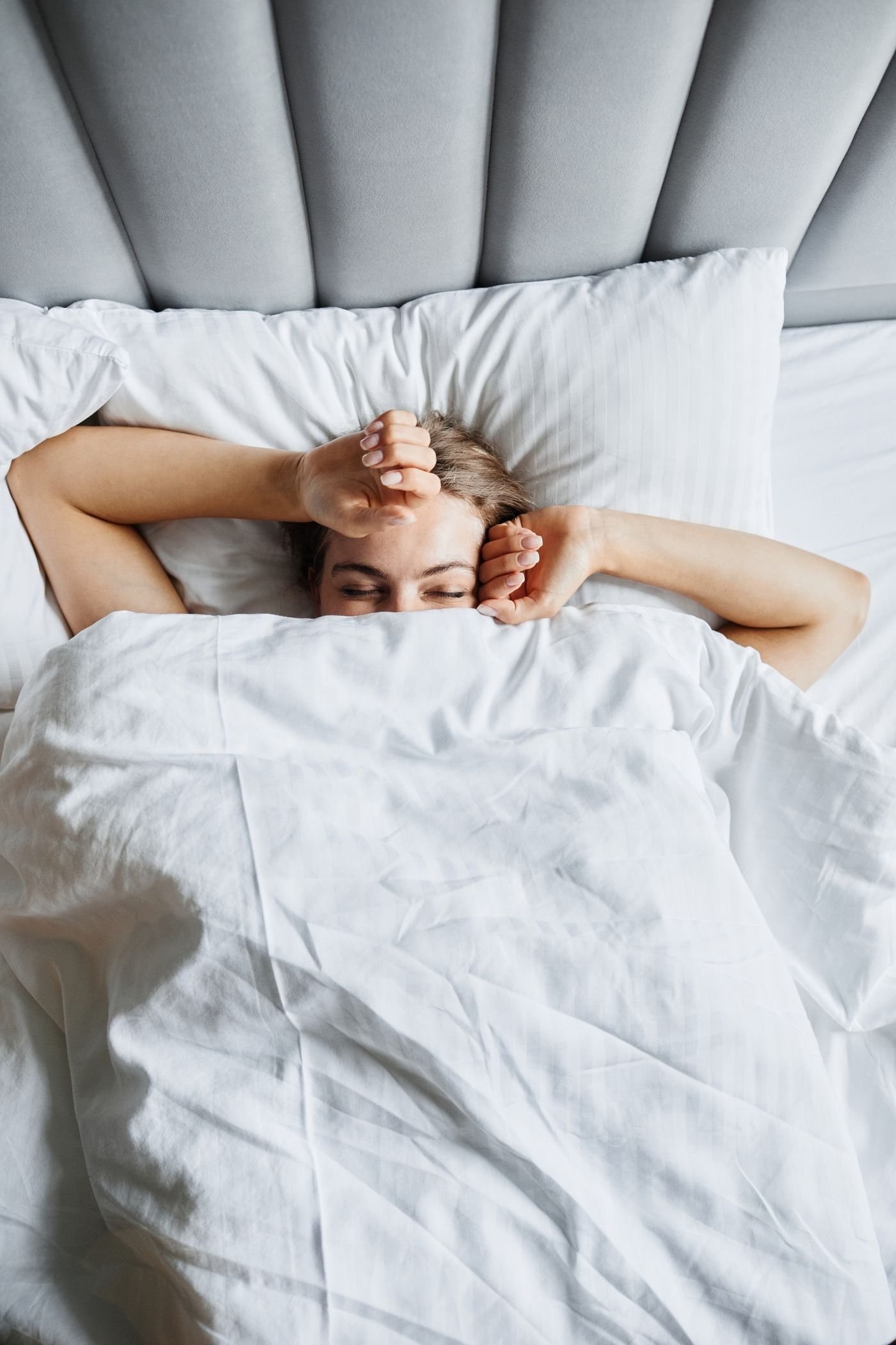 Woman resting under a blanket in the morning