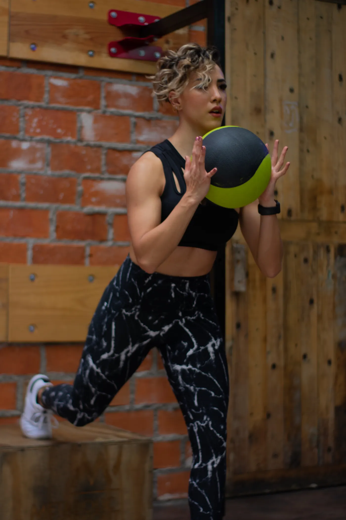 Woman exercising with a medicine ball in a gym