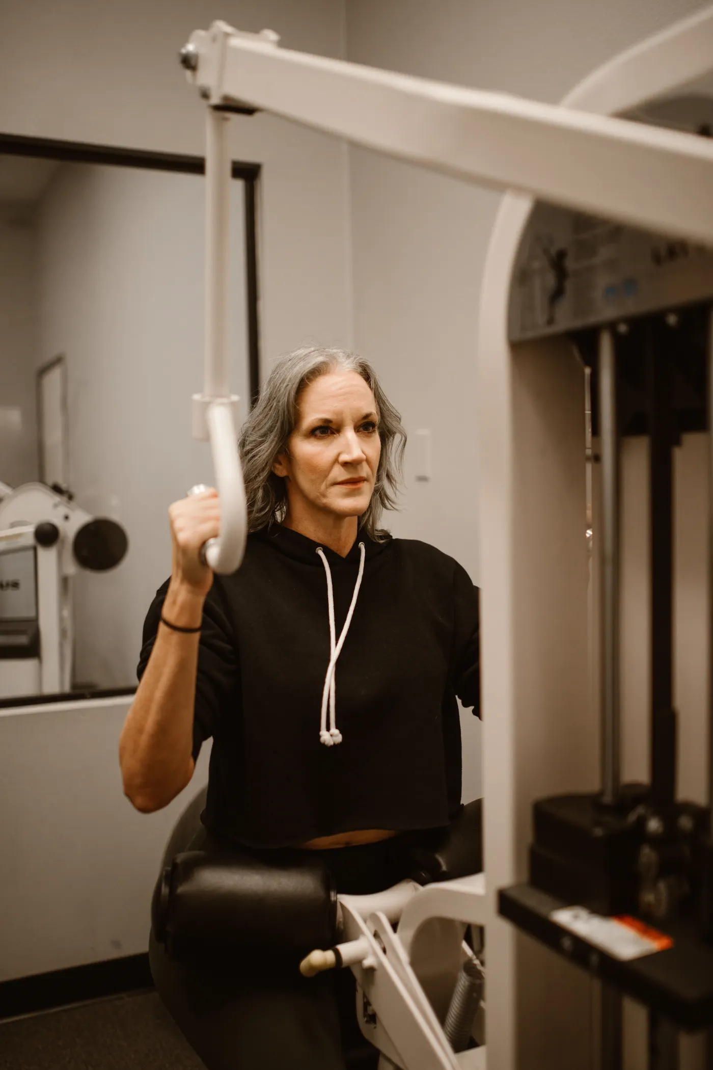 Senior woman exercising on a resistance machine in a gym