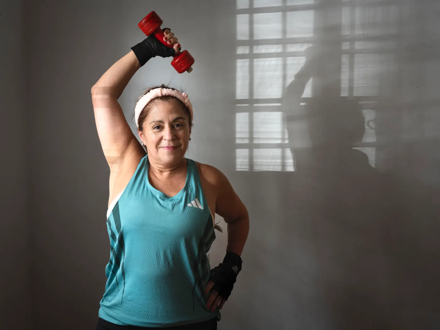 Woman lifting a dumbbell during a strength session
