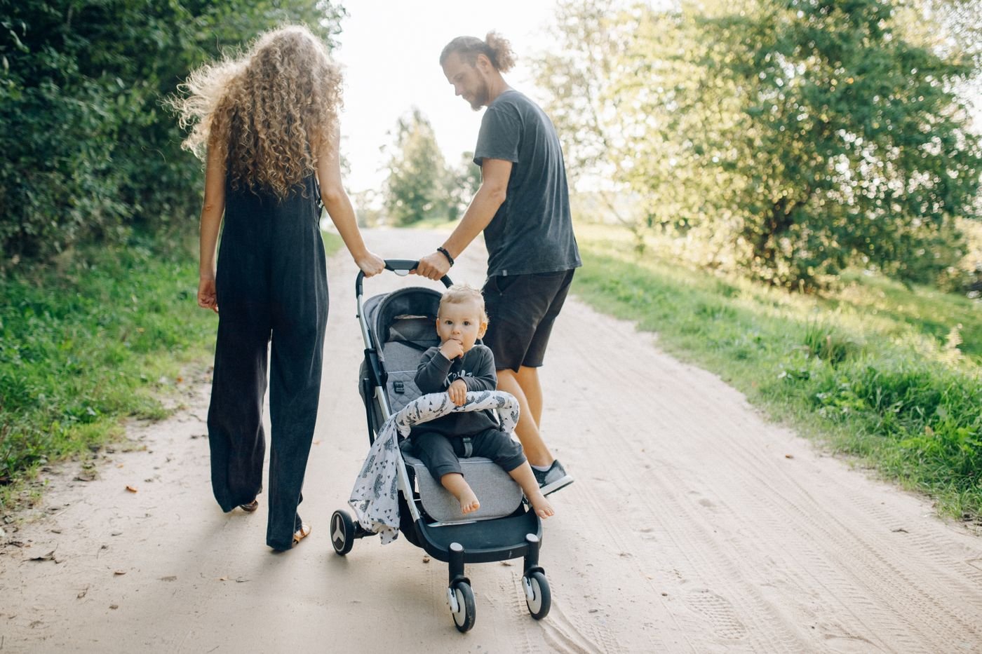 Parents walking in a park with a stroller