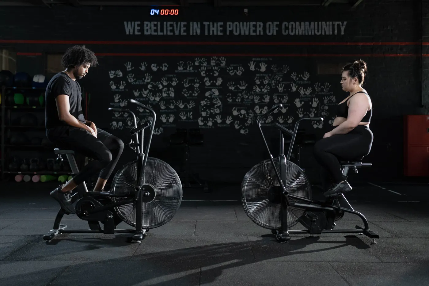 Two people riding indoor exercise bikes