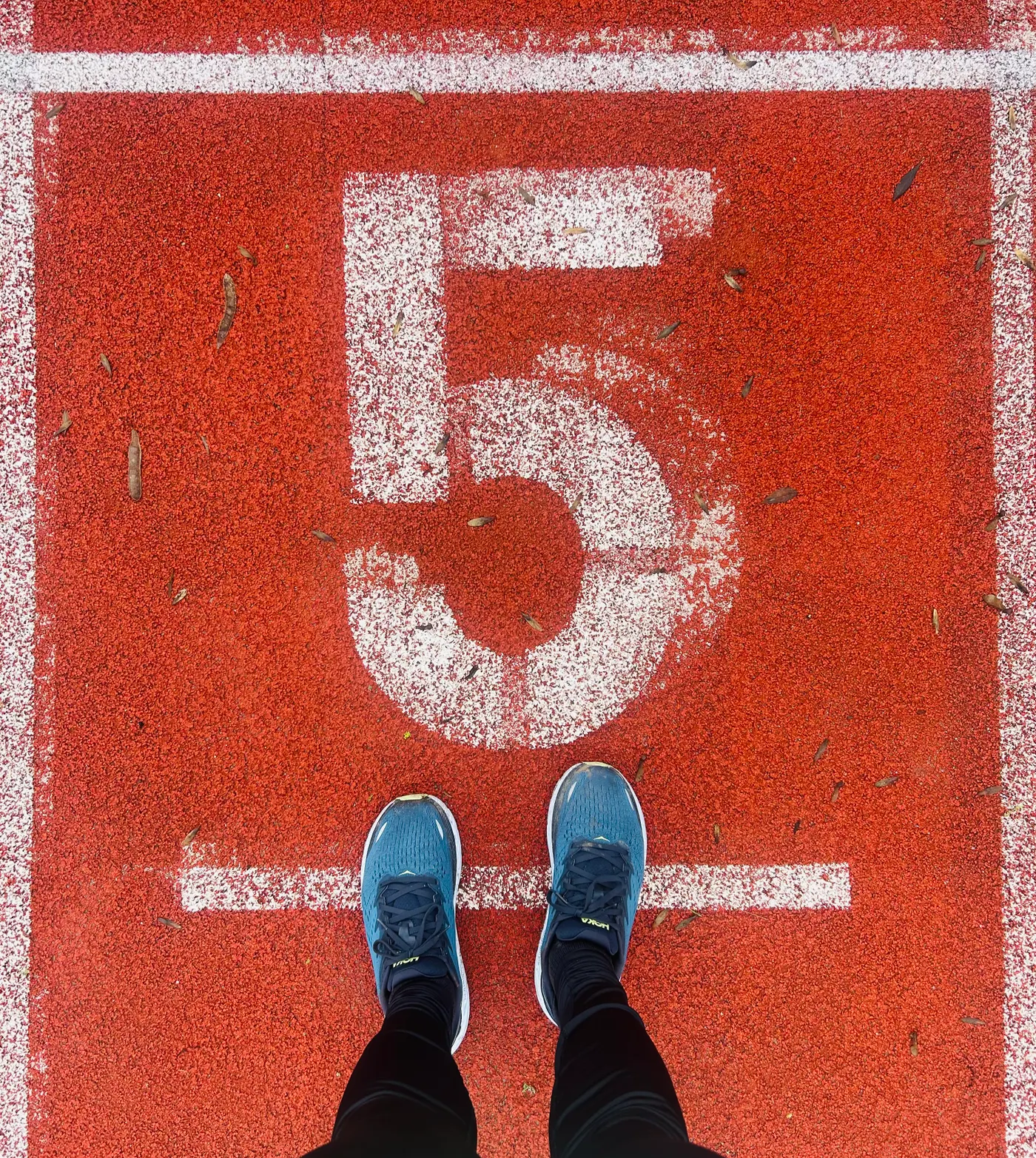 Runner's shoes on a marked athletics track