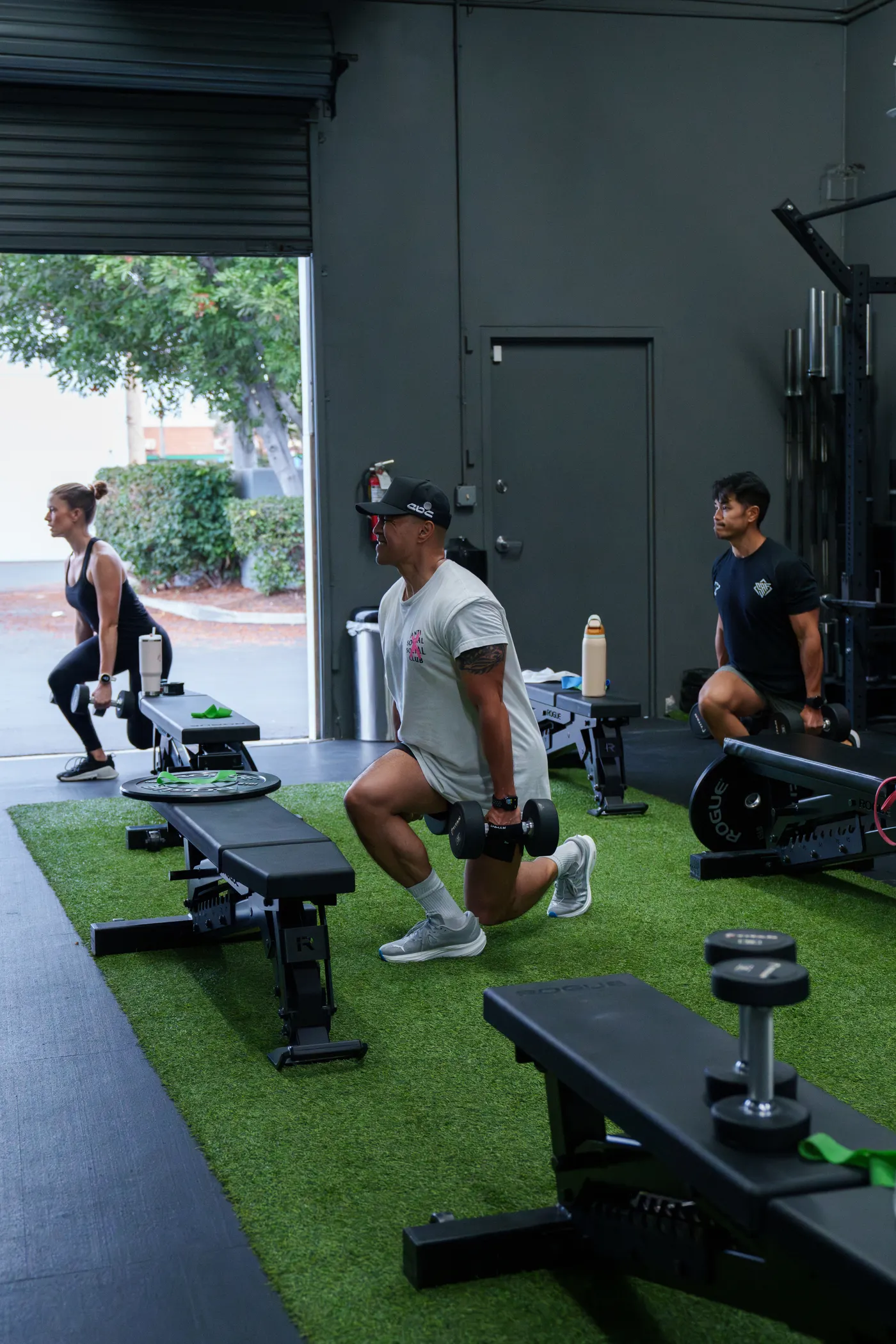 Group of athletes completing a supervised strength workout indoors