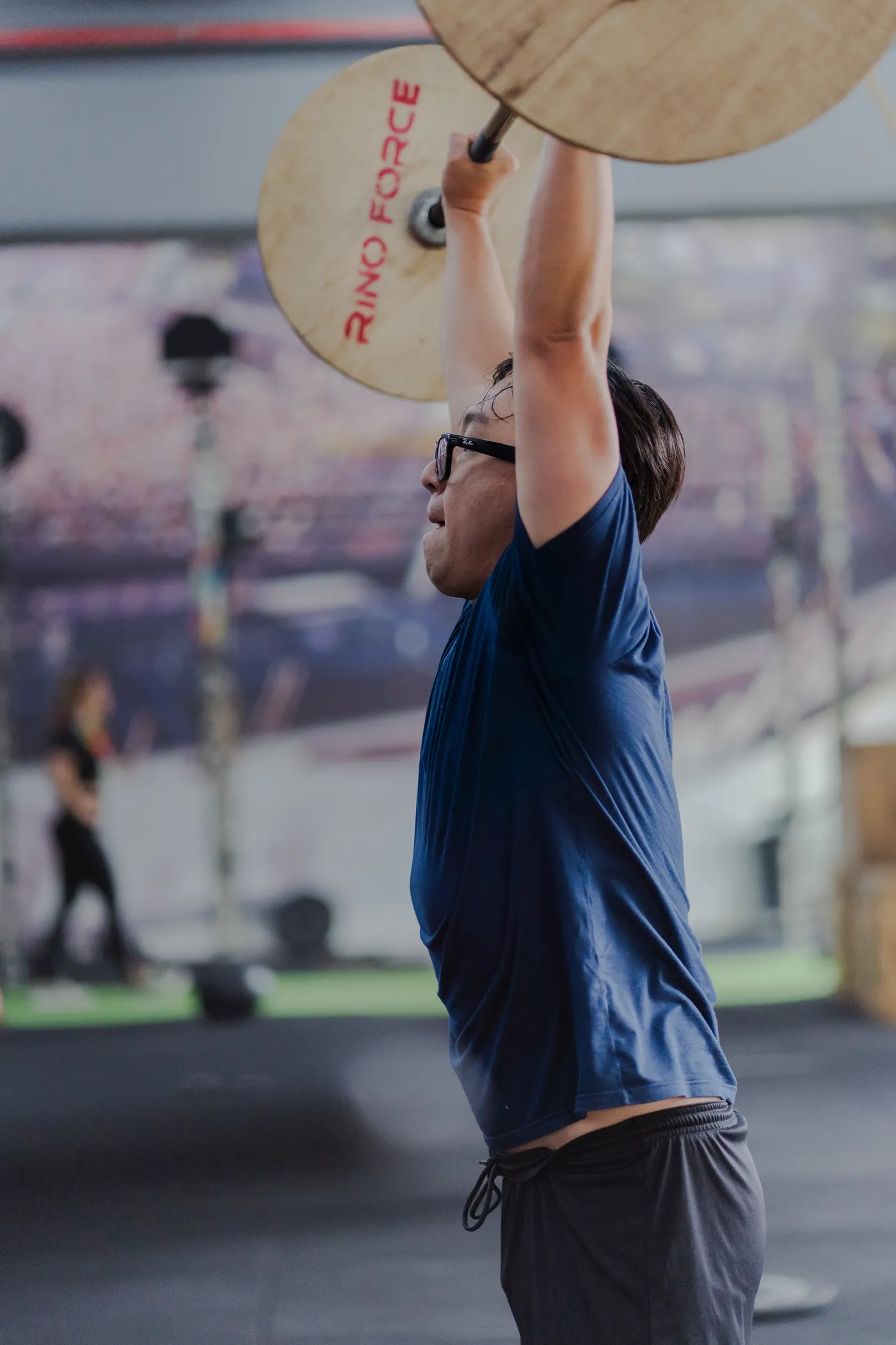 Athlete lifting a barbell overhead during strength training