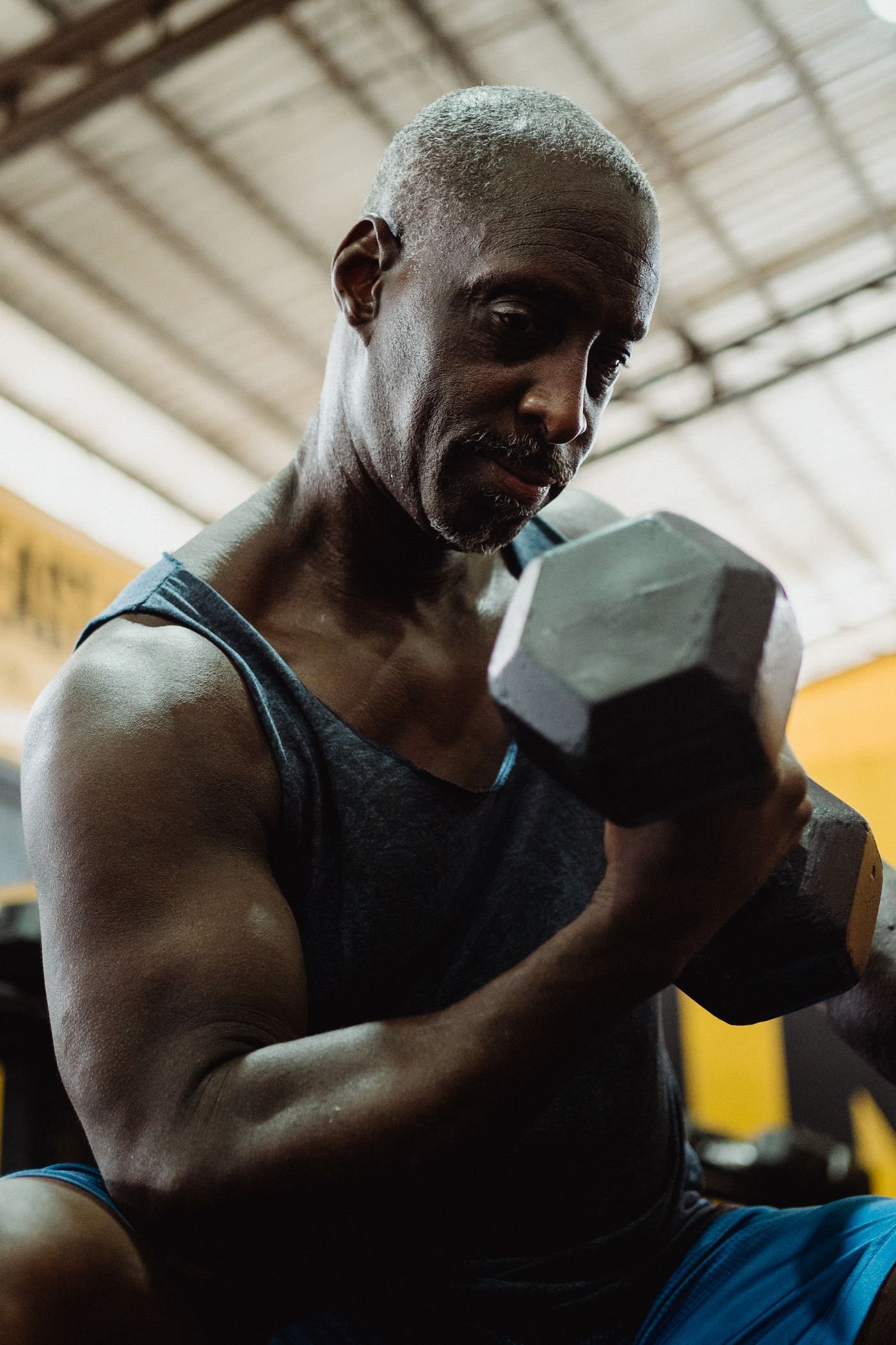 Mature man lifting a dumbbell during strength training