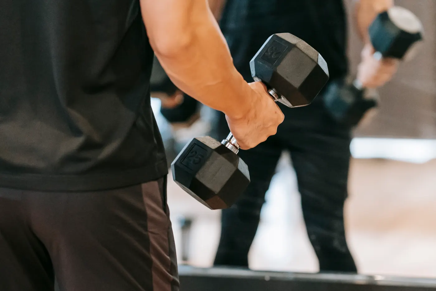 Athlete lifting dumbbells in a gym