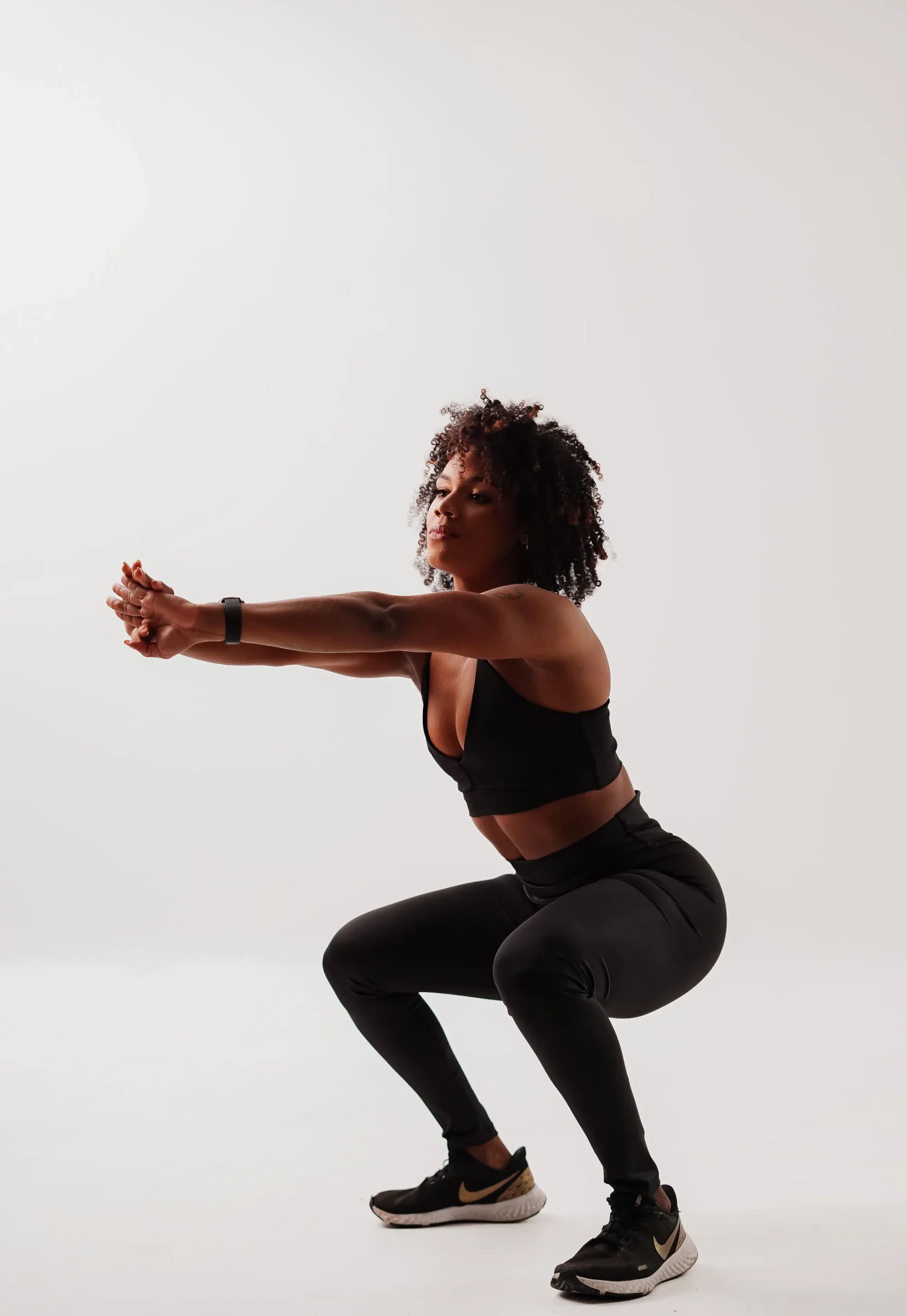 Athlete practicing bodyweight squat movement