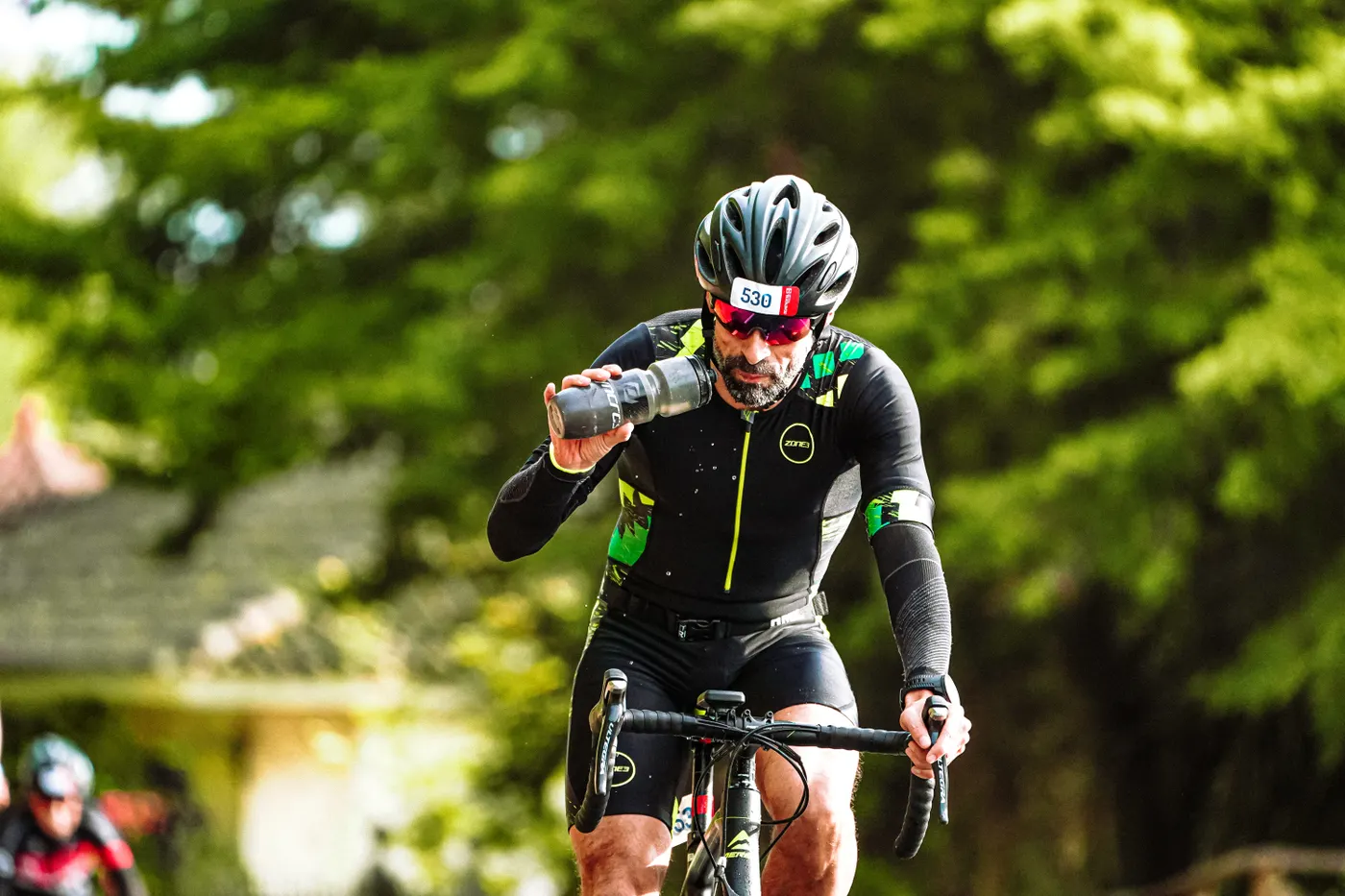 Experienced cyclist drinking water during an outdoor ride