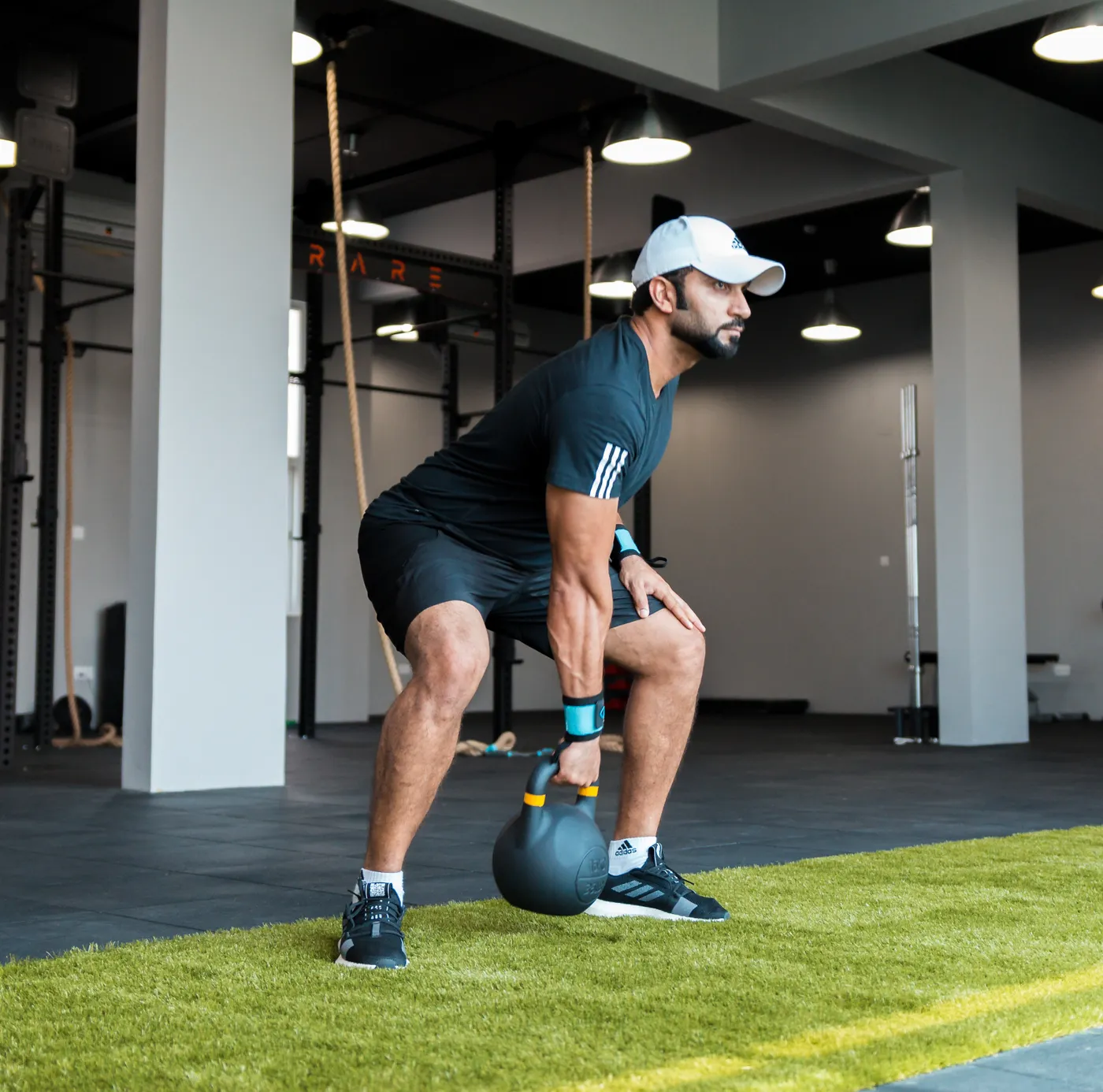 Athlete performing a kettlebell swing during strength-and-power training