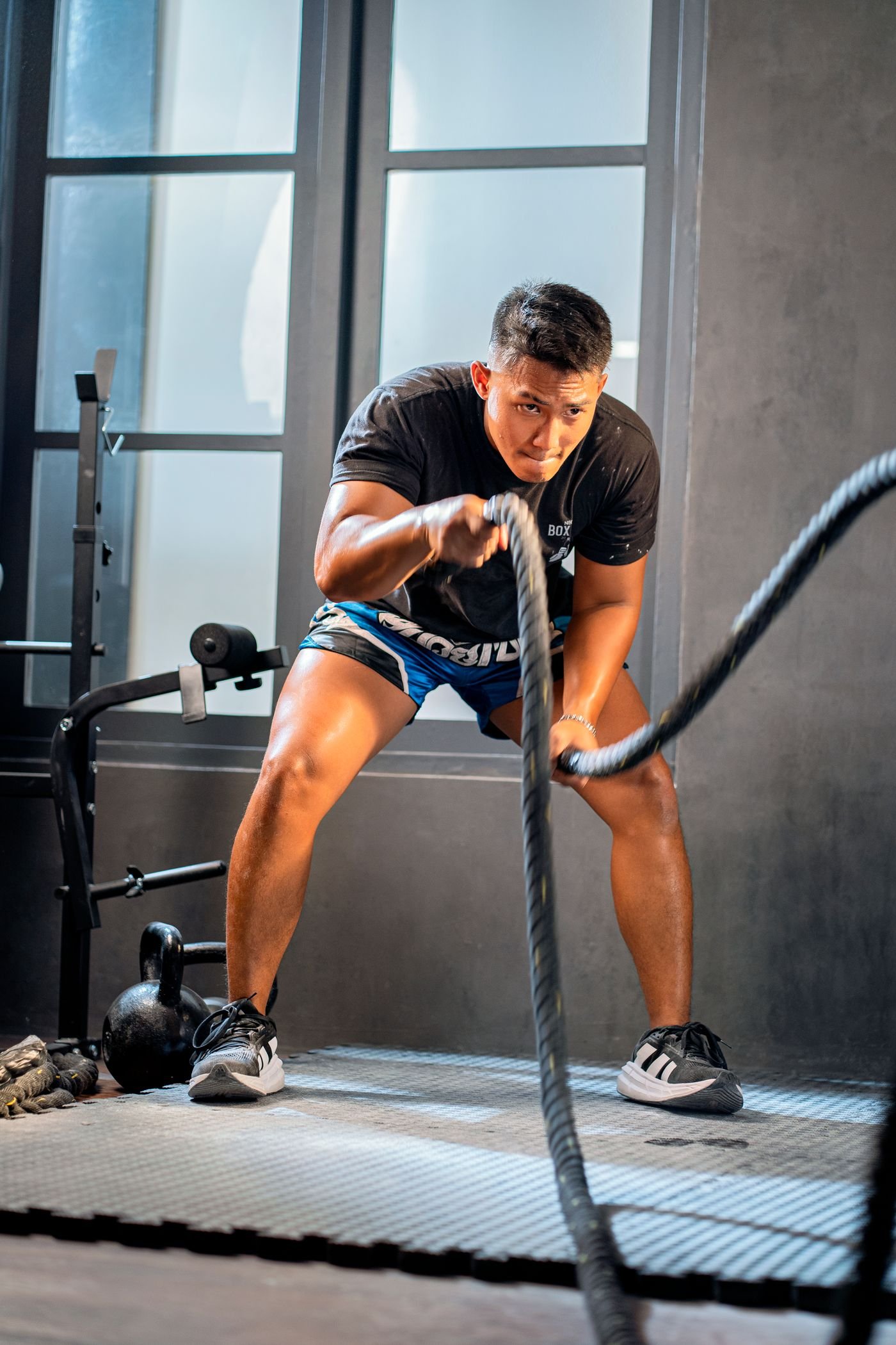 Athlete working with battle ropes during a demanding conditioning set