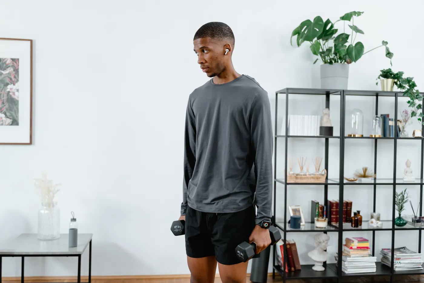 Man exercising with dumbbells at home