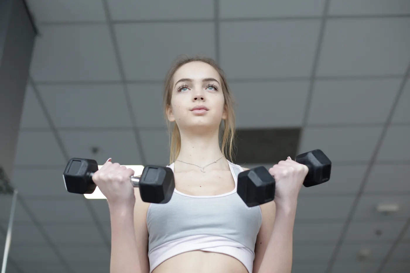 Woman performing a dumbbell strength exercise