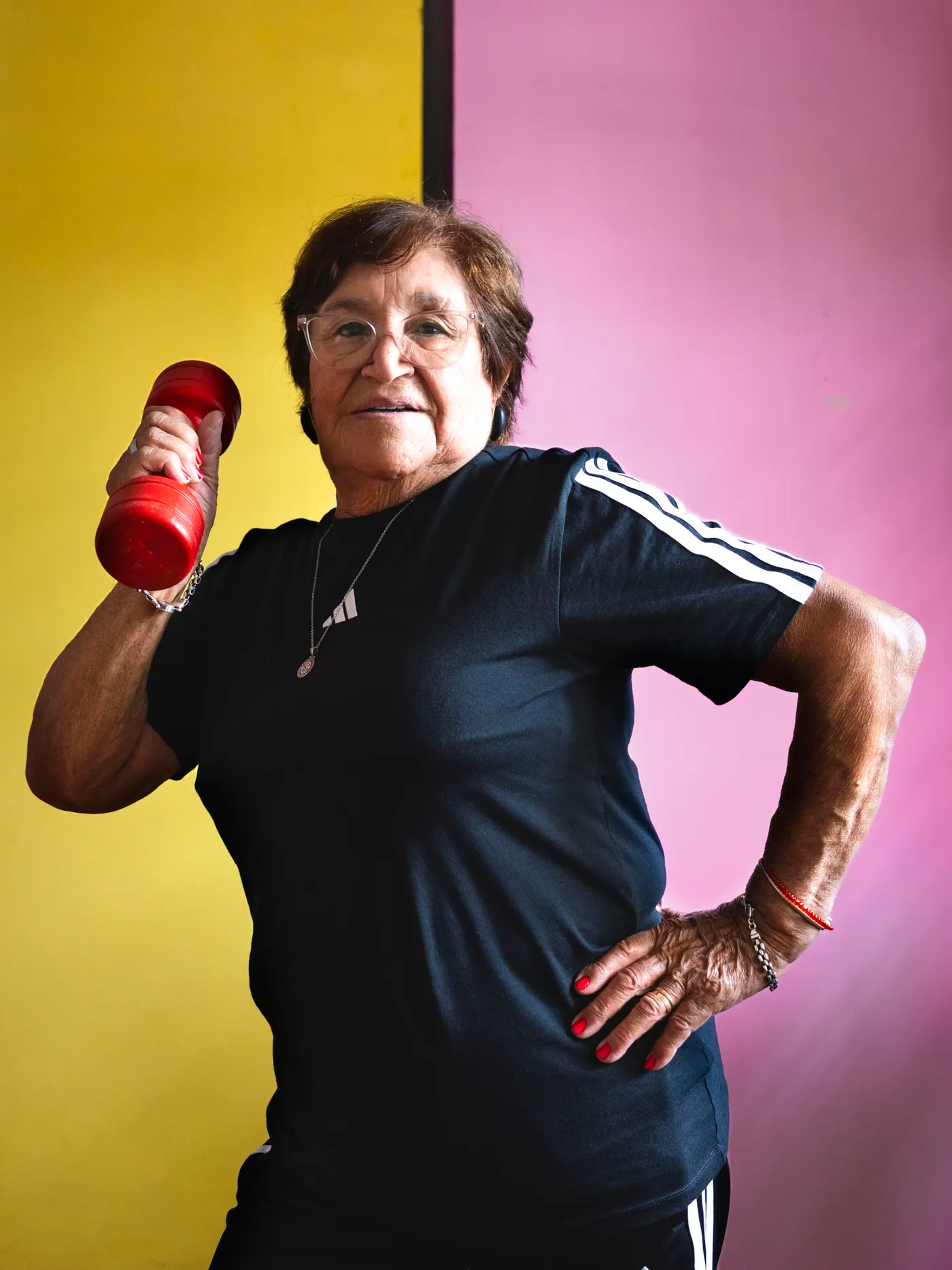 Older woman performing a dumbbell strength exercise
