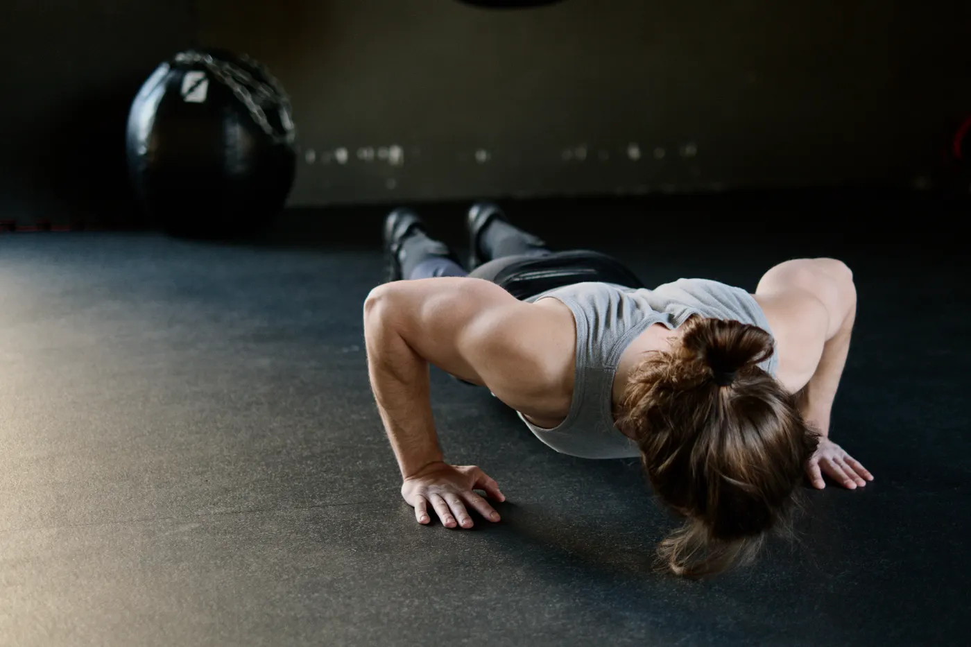 Man performing push-ups on a gym floor