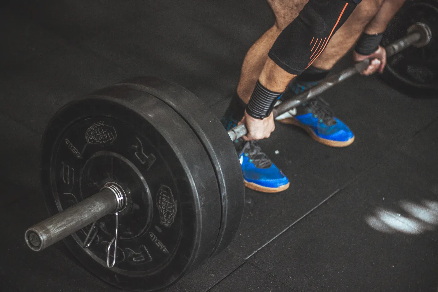 Athlete deadlifting a barbell to train hip and leg strength