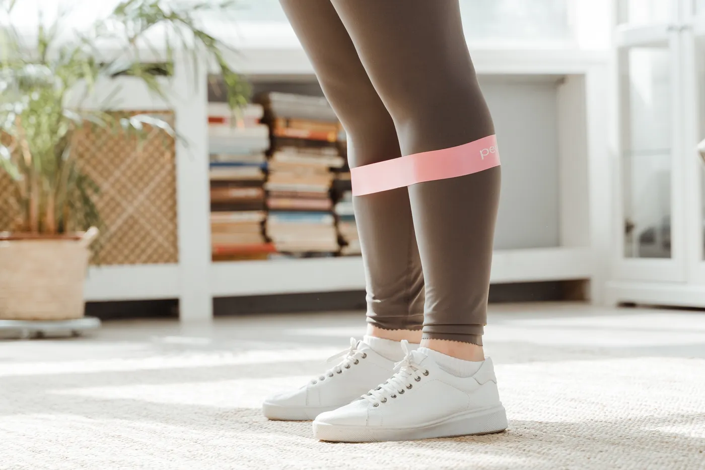 Close-up of resistance band placement around an athlete's legs