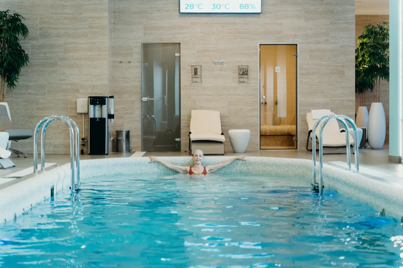 Older woman moving through an indoor swimming pool
