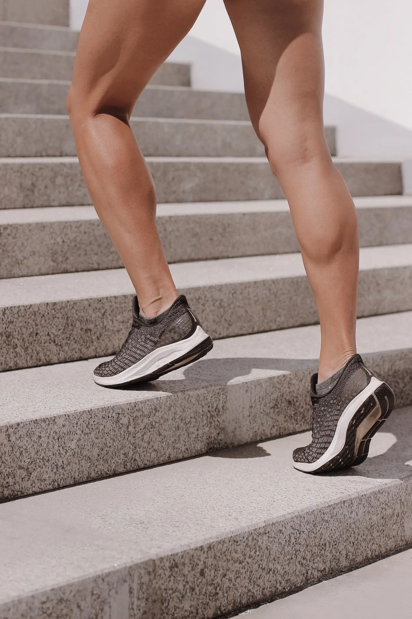 Athletic shoes climbing outdoor steps, illustrating daily movement