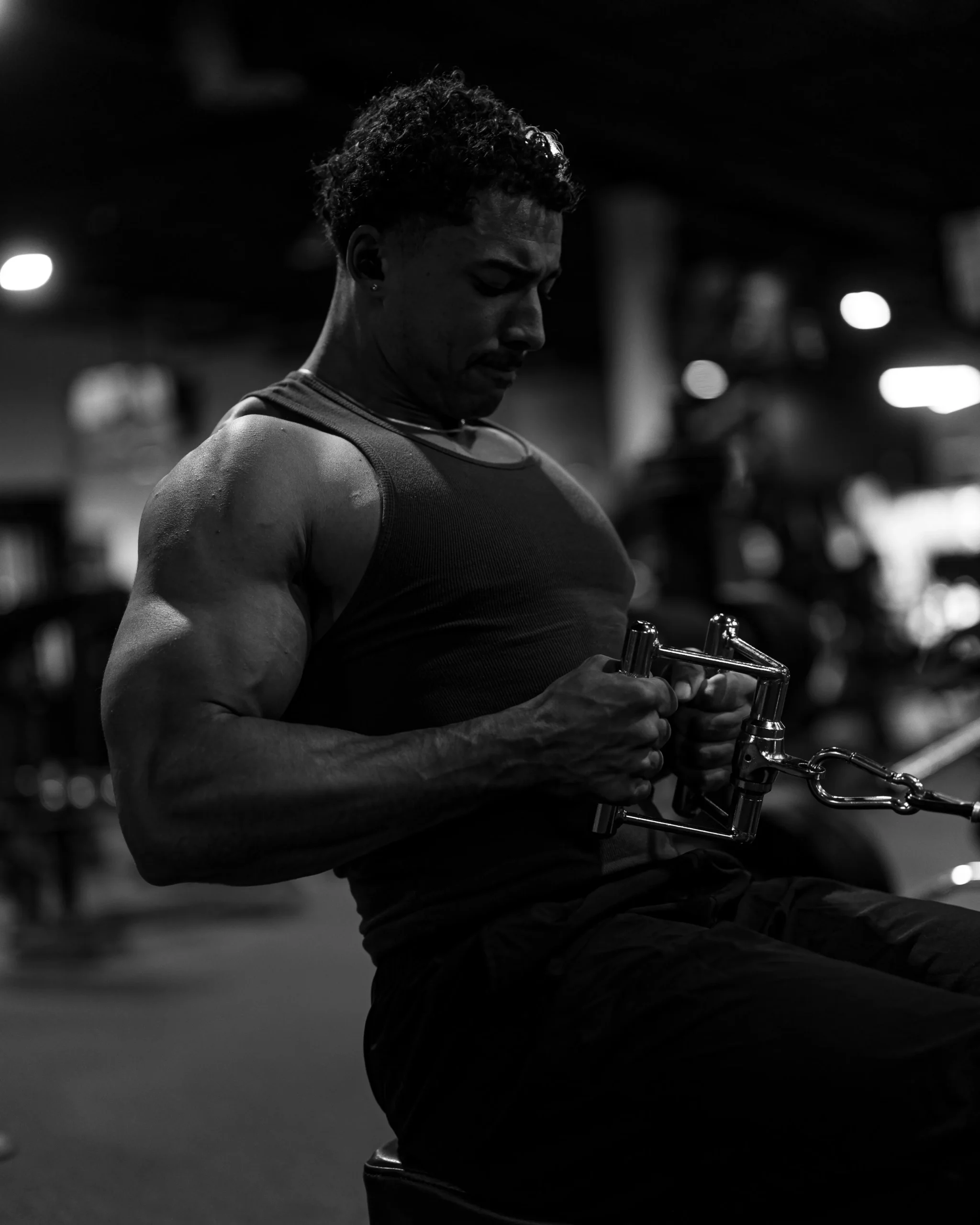 Man performing a cable exercise in a modern gym