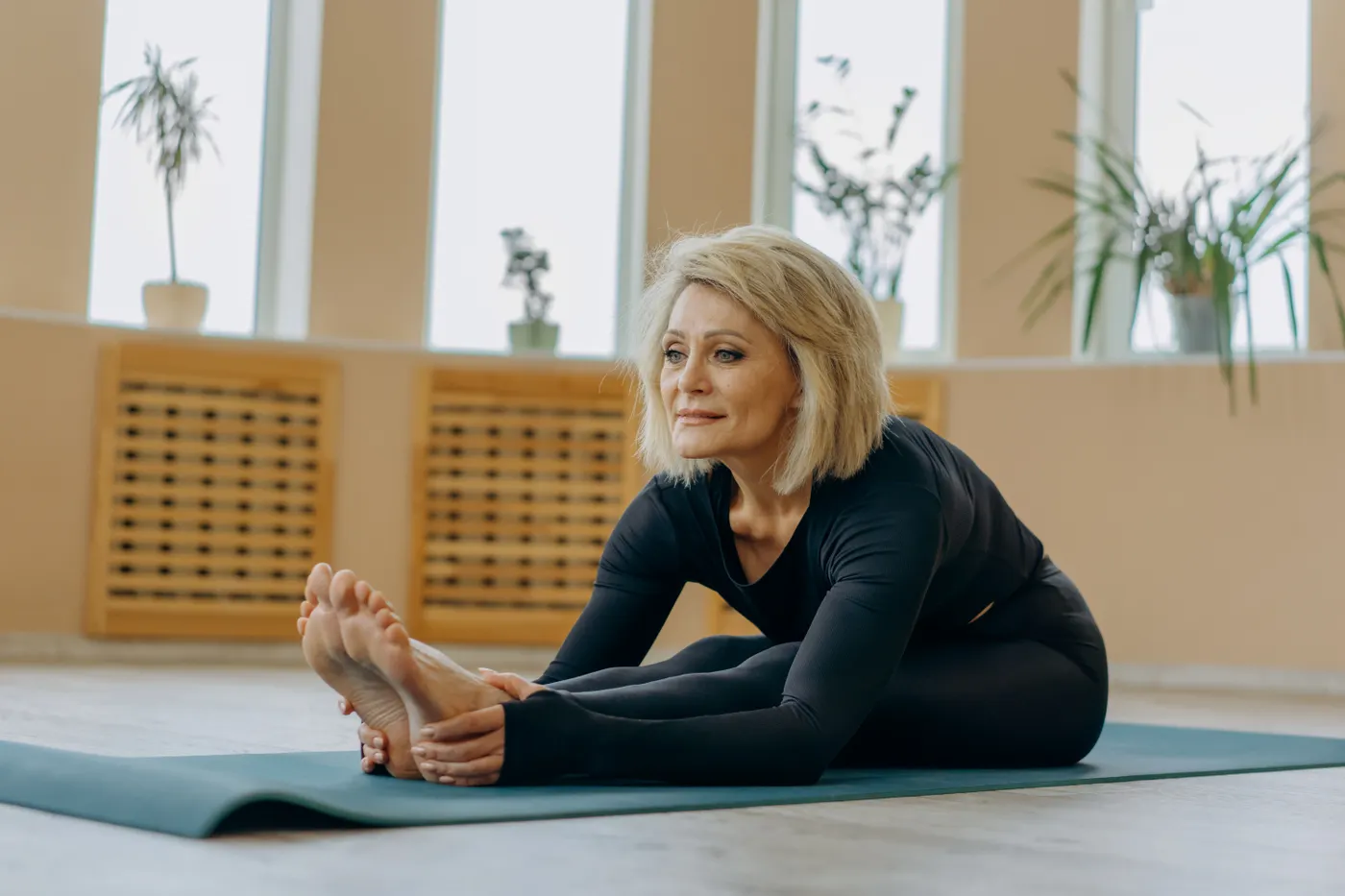 Older woman stretching on a yoga mat