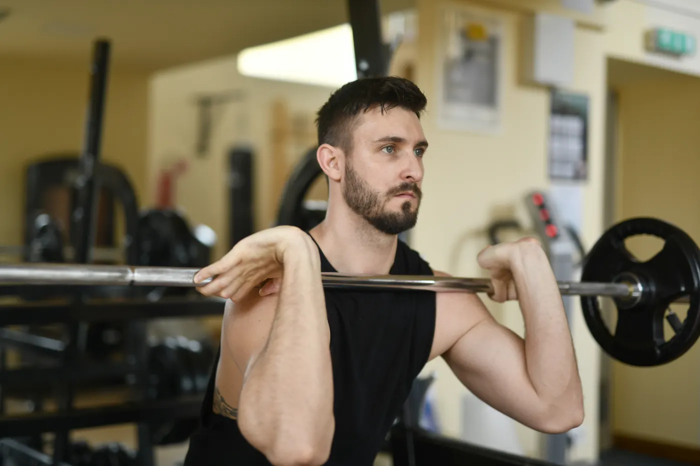 Athlete training with a barbell in a front-rack position