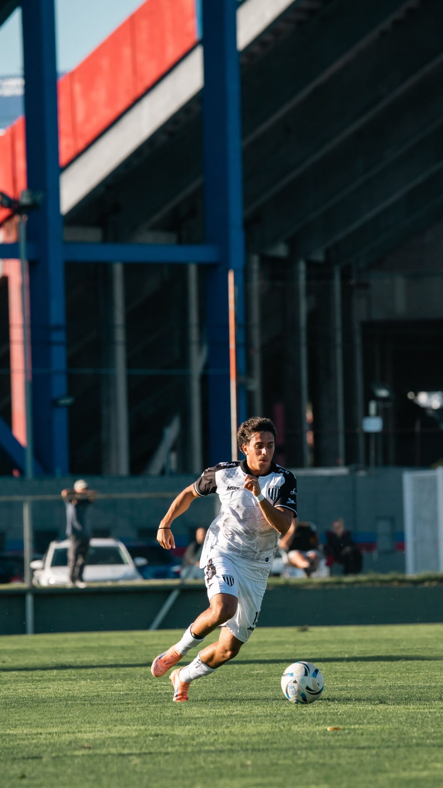 Soccer player accelerating with the ball during a match