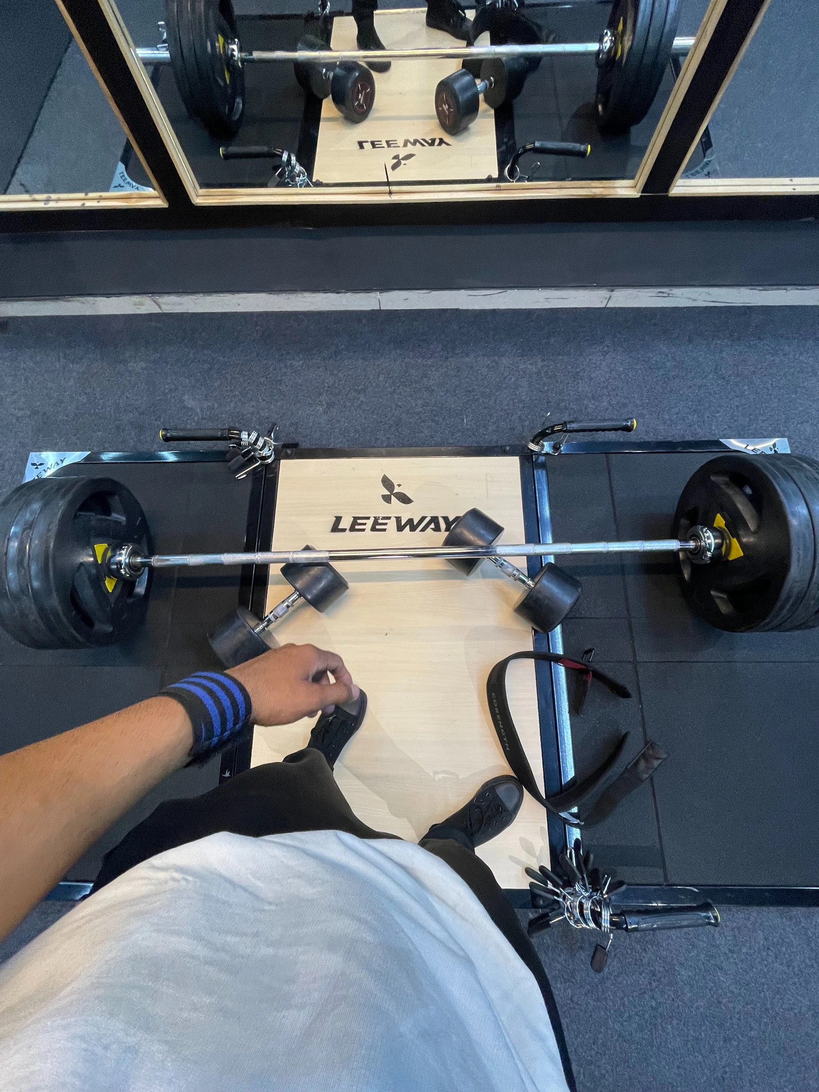 Lifter at a bench press station with a barbell before strength training