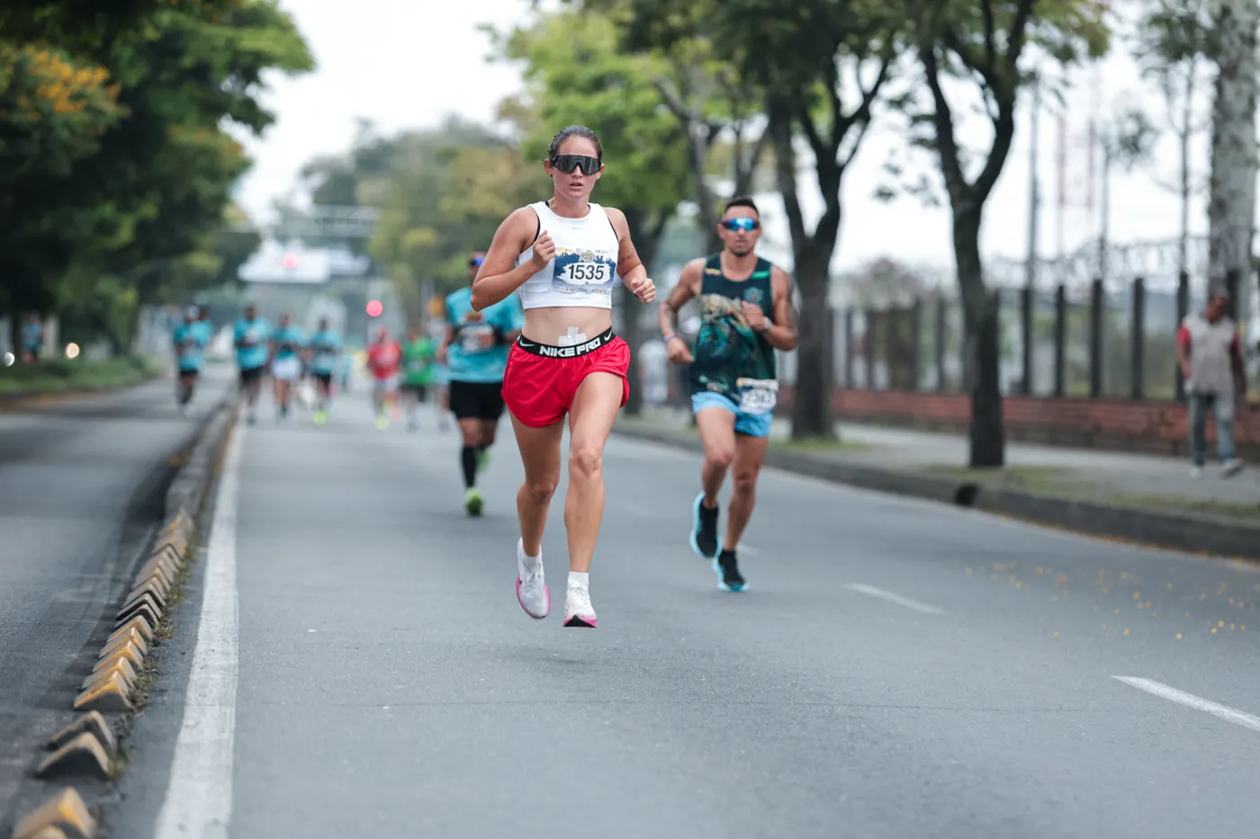 Distance runners moving along a city road