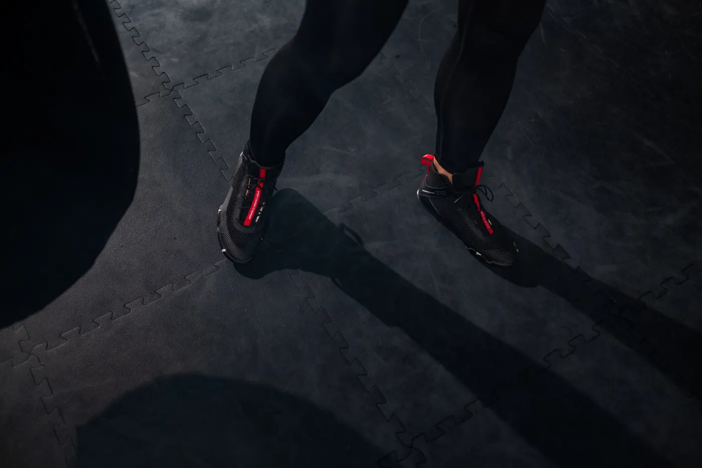 Close-up of athletic shoes positioned on a gym exercise mat