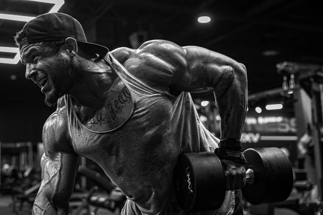 Lifter performing a controlled dumbbell exercise in a gym