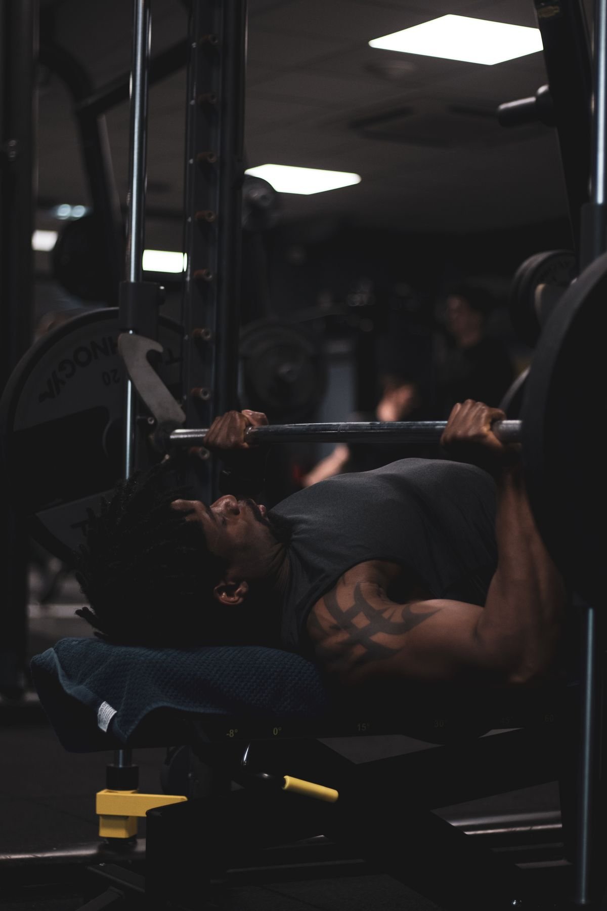 Lifter performing a barbell bench press in a gym