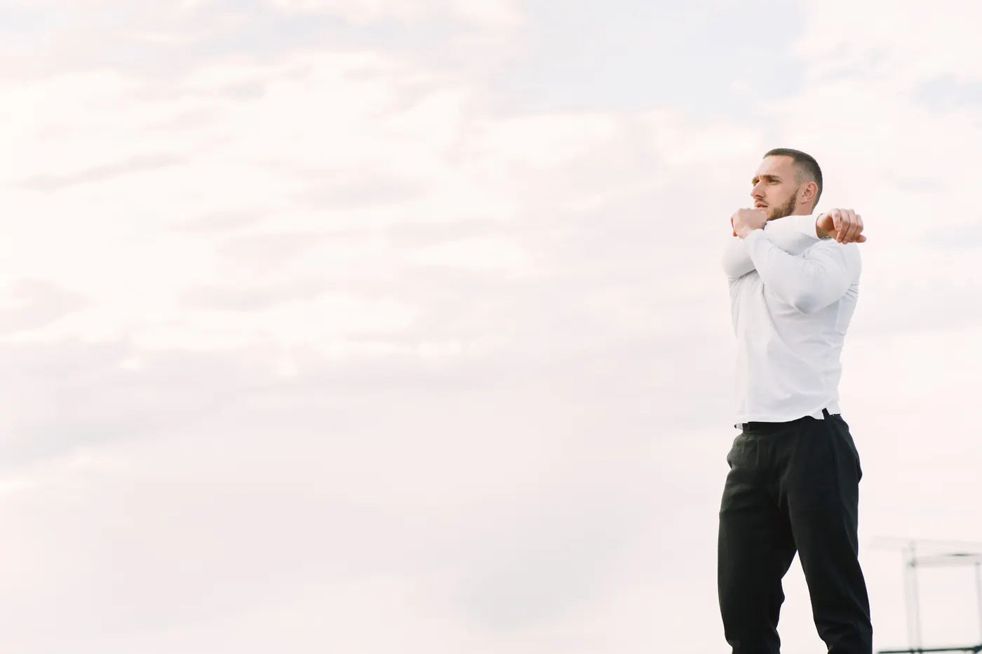 Man stretching his arms outdoors