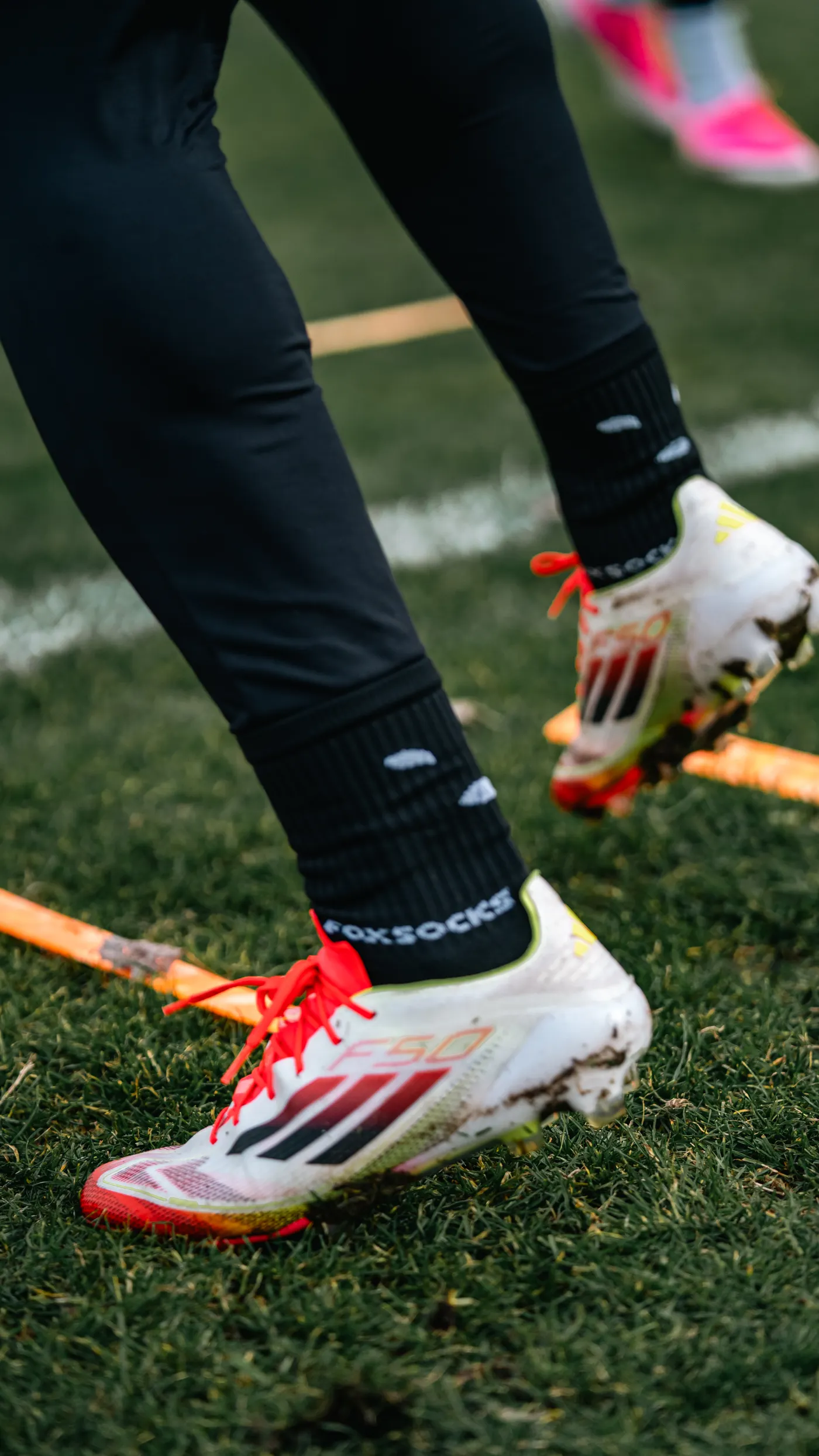 Athlete moving through a speed ladder during footwork training