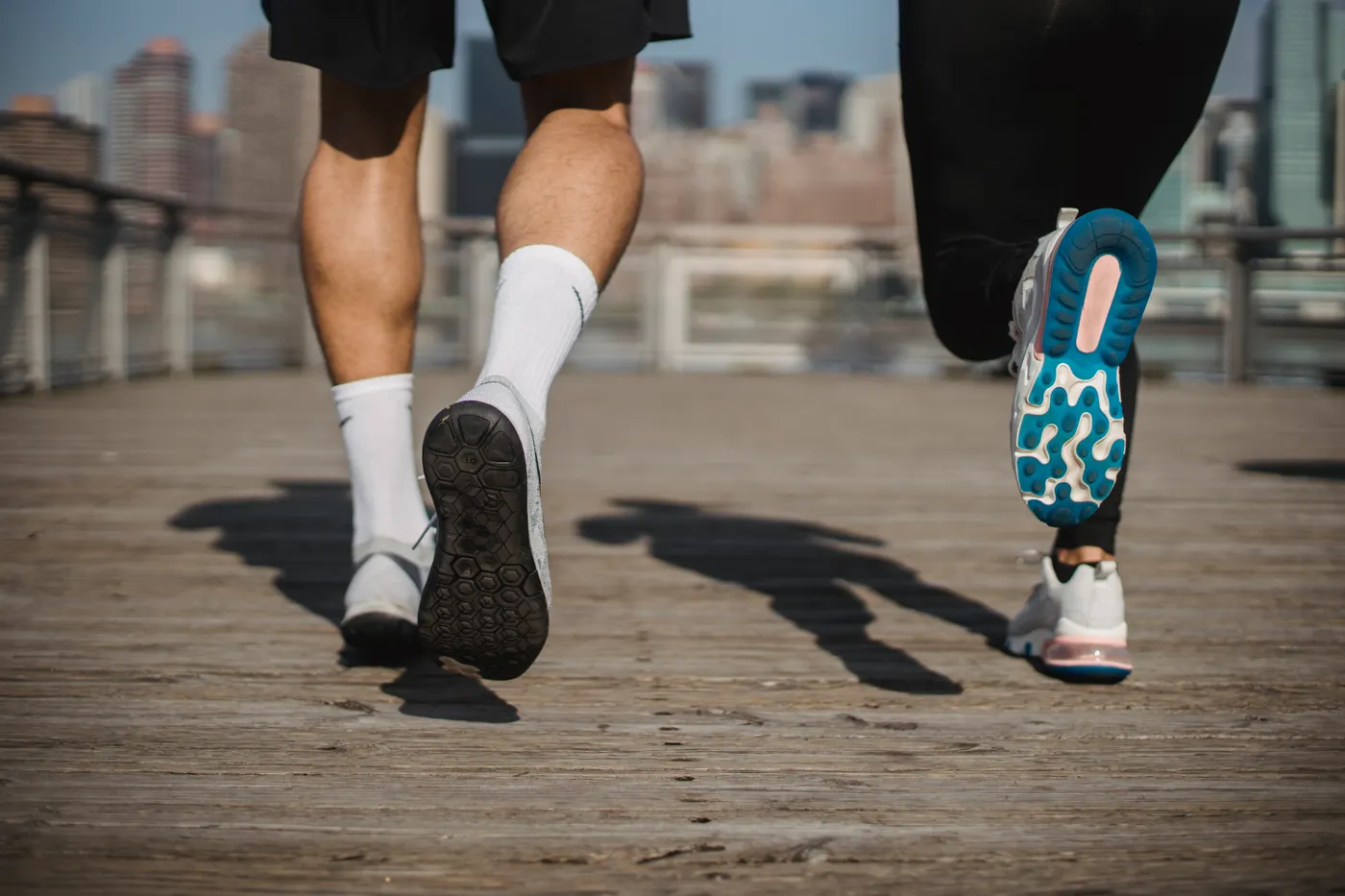 Runners crossing a city bridge during an urban training run