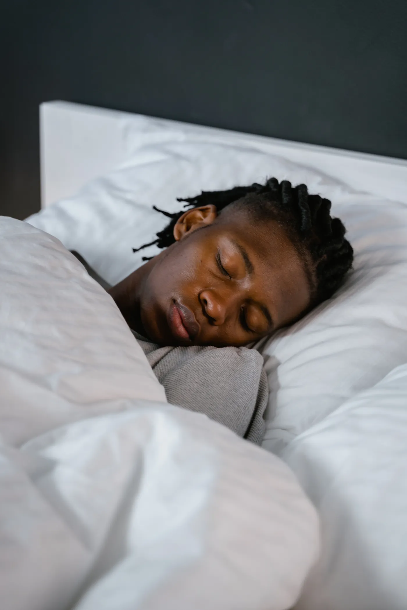 Person sleeping in bed during overnight recovery