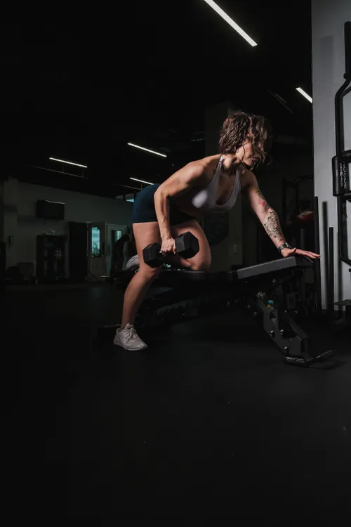 Athlete lifting a dumbbell during a focused gym session