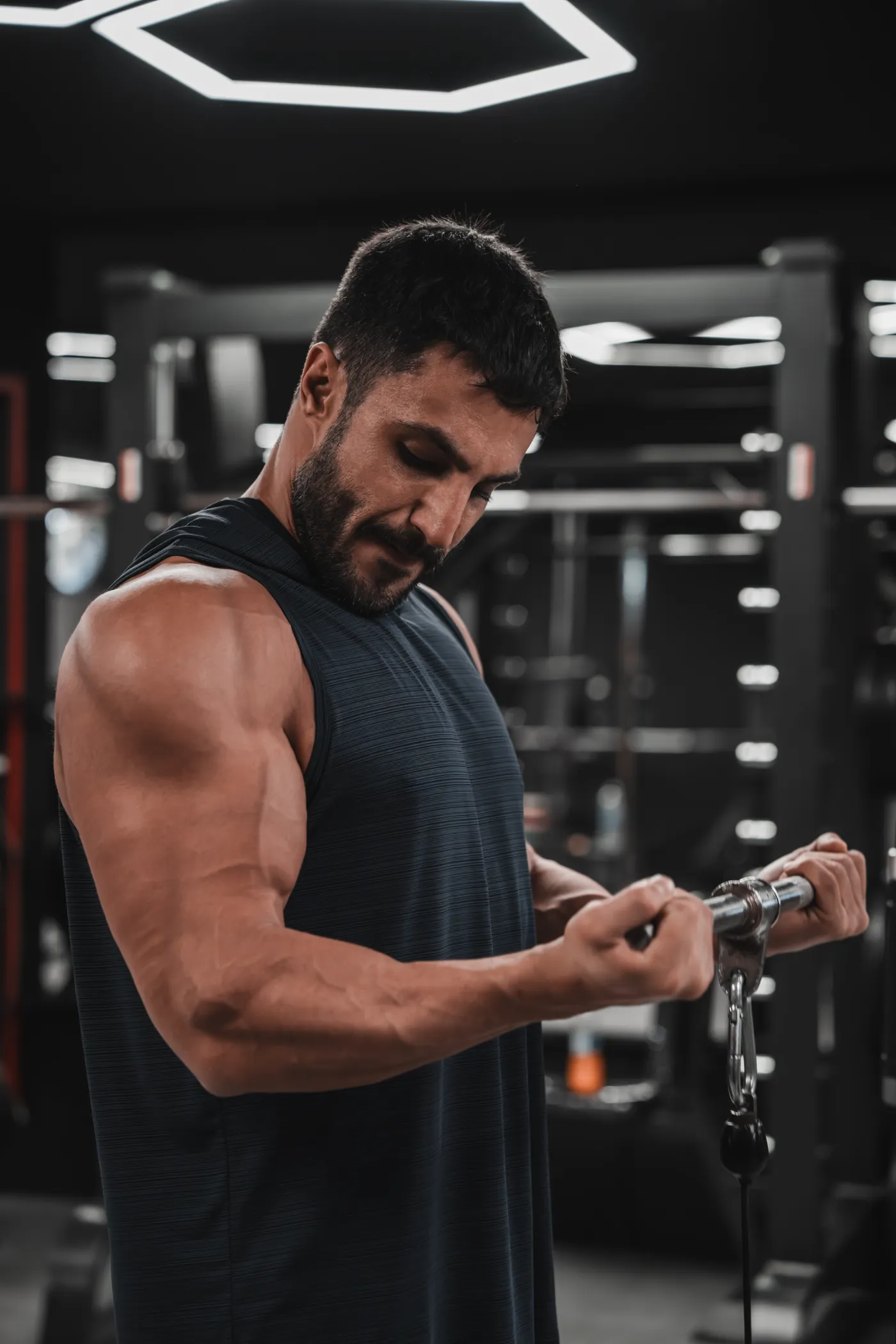 Athlete performing a cable biceps curl in a fitness center