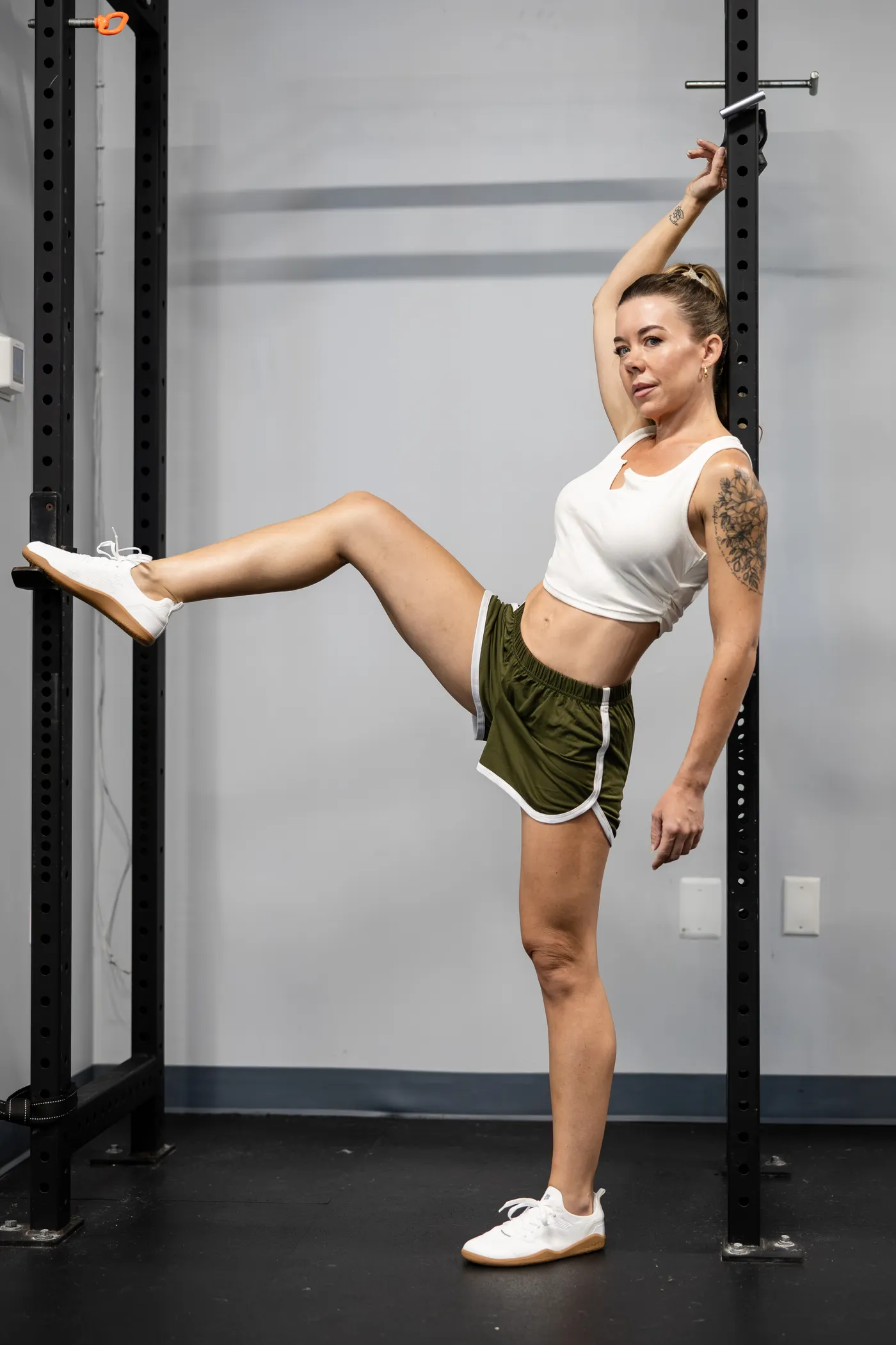 Woman stretching her leg in a gym between workouts