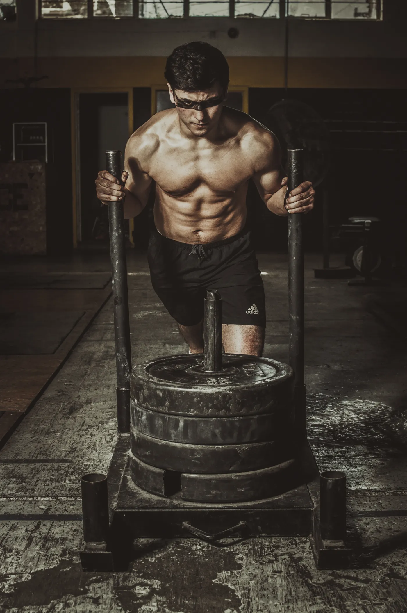 Man leaning into a heavy sled push