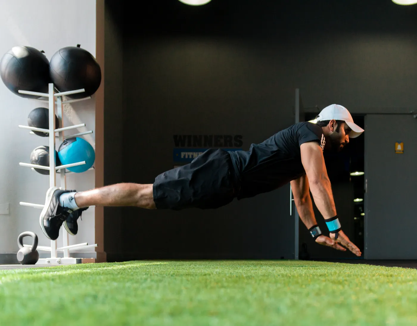 Athlete performing an explosive push-up on a gym floor