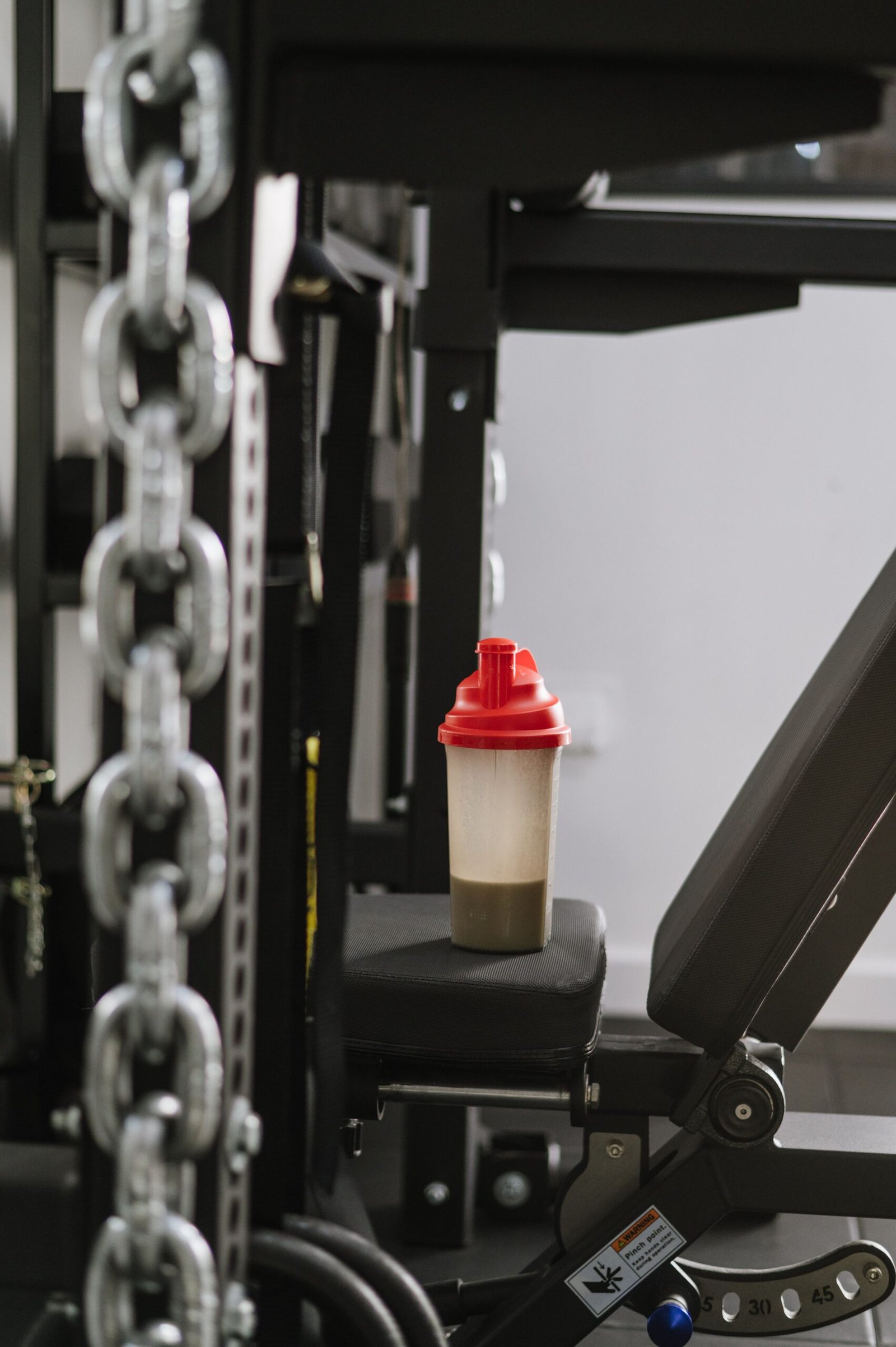 Shaker bottle resting on gym equipment