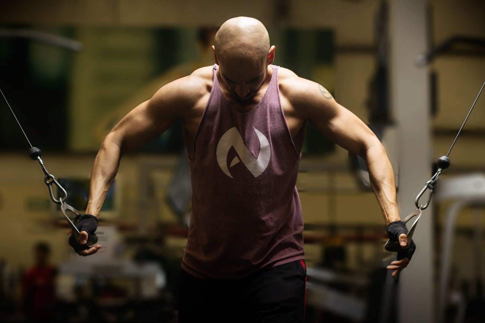 Man performing a cable resistance exercise in a gym