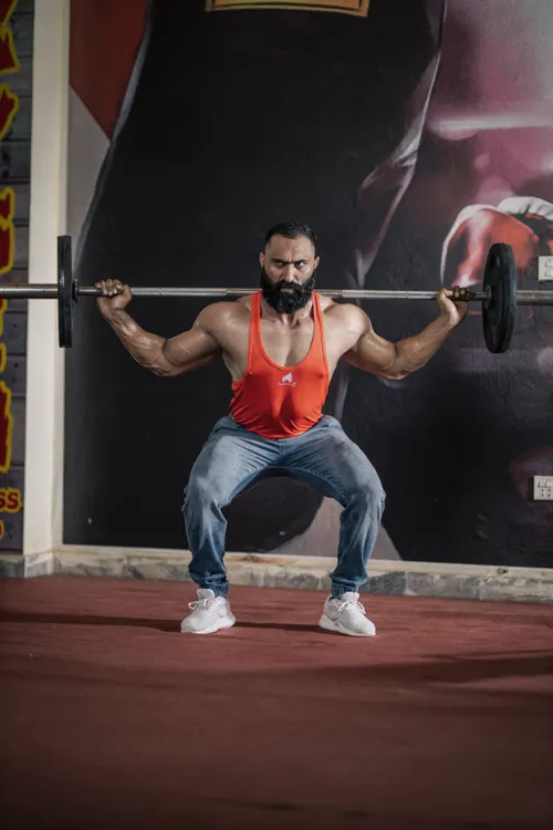 Athlete performing a barbell squat during strength training