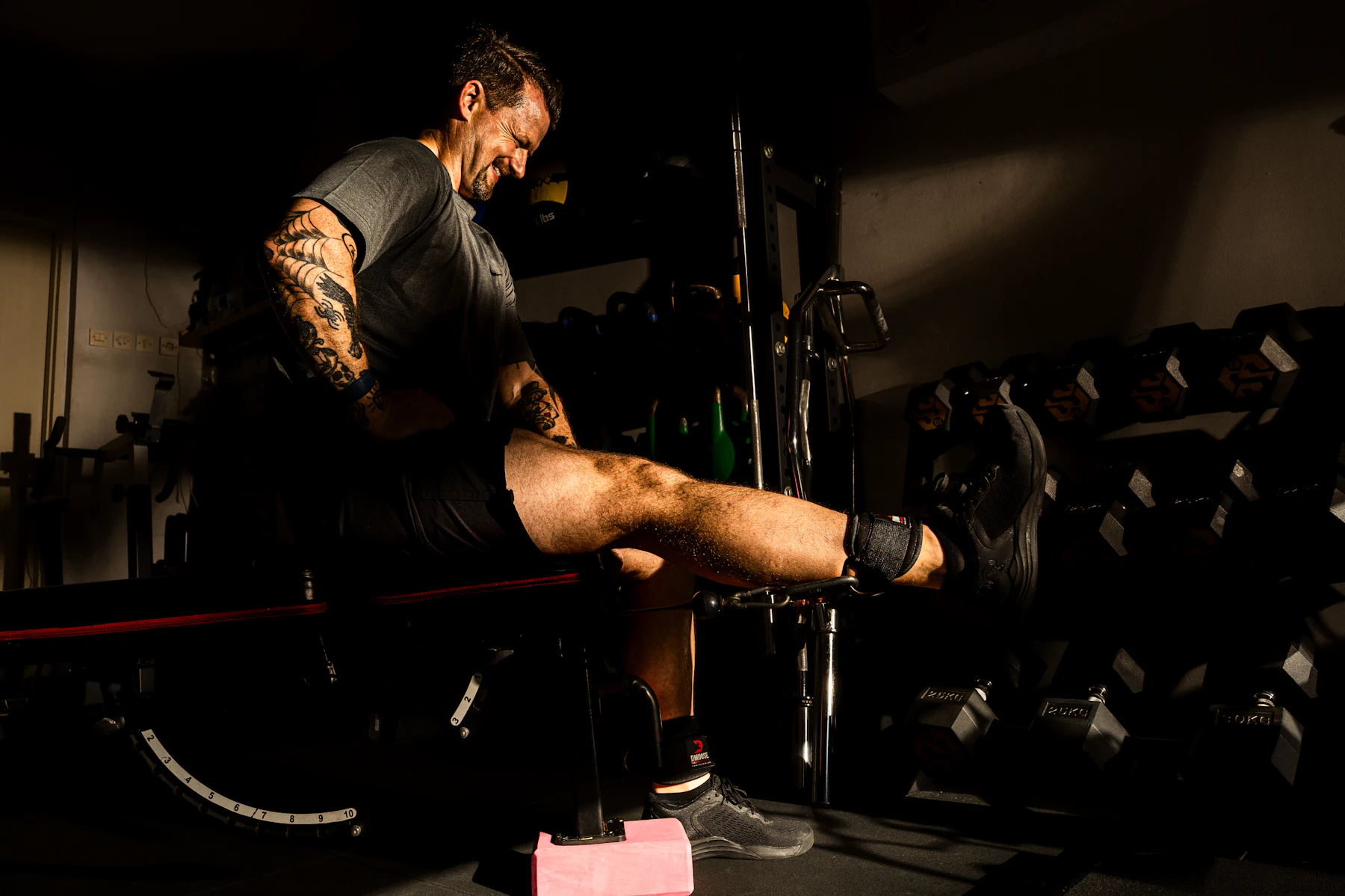 Athlete using a seated leg-extension machine to train the quadriceps
