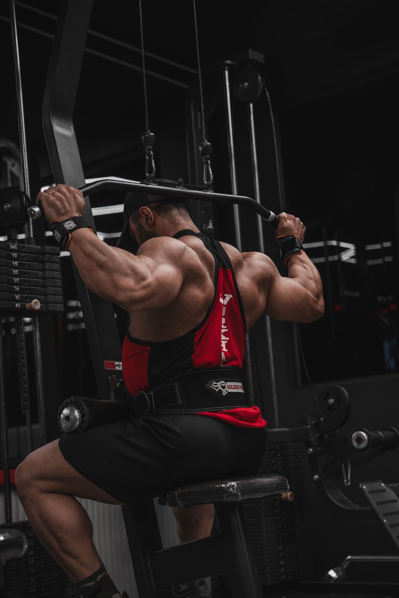 Bodybuilder performing a lat pulldown for back and elbow-flexor work
