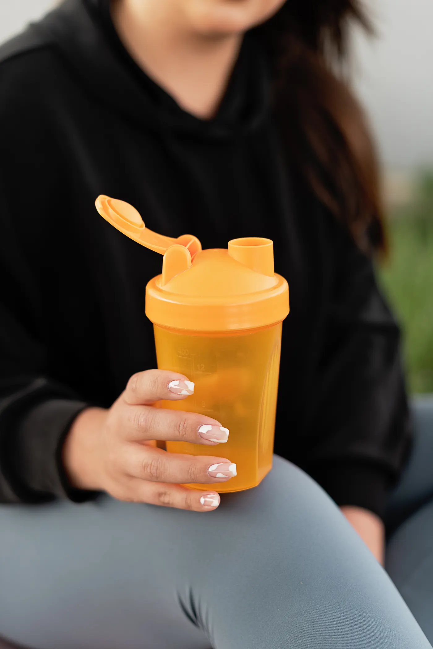 Person holding a shaker bottle after training