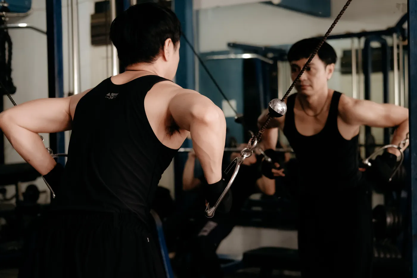 Athlete performing cable resistance training in a gym